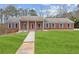 Classic brick home with blue shutters, manicured lawn, and inviting walkway at 3113 Melissa Ct, Douglasville, GA 30135