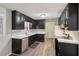 Well-lit kitchen featuring black cabinets, stainless steel appliances, and modern countertop at 3113 Melissa Ct, Douglasville, GA 30135