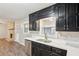 Modern kitchen with black cabinets, stainless steel dishwasher, and stone backsplash at 3113 Melissa Ct, Douglasville, GA 30135