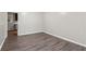 Inviting room with new wood flooring, neutral walls, and a glimpse of the kitchen at 3113 Melissa Ct, Douglasville, GA 30135