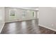 Spacious living room featuring hardwood floors, neutral walls, and natural light from three windows at 3113 Melissa Ct, Douglasville, GA 30135