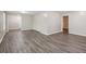 Spacious room featuring new wood flooring, neutral walls, and multiple entryways at 3113 Melissa Ct, Douglasville, GA 30135