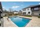 Gorgeous backyard featuring a sparkling pool, lounge seating, and well-maintained lawn at 557 Loth Wages Rd, Dacula, GA 30019