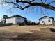 View of the home and detached structure; ample backyard space ready for outdoor activities and landscaping projects at 557 Loth Wages Rd, Dacula, GA 30019