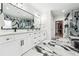 Luxury bathroom featuring double vanities, statement mirrors, and walk-in shower at 557 Loth Wages Rd, Dacula, GA 30019