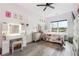 Bedroom with wood floors, natural light, modern decor, and vanity with lighted mirror at 557 Loth Wages Rd, Dacula, GA 30019