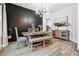 Stylish dining room featuring hardwood floors, modern decor, and a designer light fixture at 557 Loth Wages Rd, Dacula, GA 30019