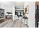 Elegant foyer with hardwood floors, staircase, artwork, and stylish console table at 557 Loth Wages Rd, Dacula, GA 30019