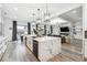 Open-concept kitchen with marble island, modern appliances, and views of the living area at 557 Loth Wages Rd, Dacula, GA 30019