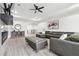 Open living room featuring wood floors, recessed lighting, ceiling fan, and modern furniture at 557 Loth Wages Rd, Dacula, GA 30019