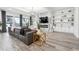 Living room showcases a large leather couch, marble fireplace, built-in shelving and hardwood flooring at 557 Loth Wages Rd, Dacula, GA 30019