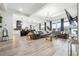 Open concept living area with hardwood floors, a modern kitchen, and ample natural light from large windows at 557 Loth Wages Rd, Dacula, GA 30019