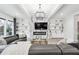 Comfortable living room includes a marble fireplace, modern chandelier, and abundant shelving on the wall at 557 Loth Wages Rd, Dacula, GA 30019