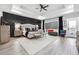A spacious main bedroom features a tray ceiling, wood accent wall, and stylish furnishings at 557 Loth Wages Rd, Dacula, GA 30019