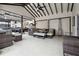 Spacious covered outdoor living area complete with comfortable seating, a bar, and a ceiling fan at 557 Loth Wages Rd, Dacula, GA 30019