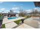 Lush backyard with private swimming pool, outdoor kitchen, and lounge areas for relaxing and entertaining at 557 Loth Wages Rd, Dacula, GA 30019