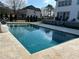 Relaxing pool with travertine tile surround, perfect for enjoying sunny days in a serene setting at 557 Loth Wages Rd, Dacula, GA 30019