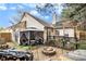 Landscaped backyard with an outdoor fire pit, patio seating and string lights offers a cozy entertaining space at 11765 Fairway Overlook, Fayetteville, GA 30215