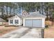 Lovely home with attached garage surrounded by lush greenery at 11765 Fairway Overlook, Fayetteville, GA 30215