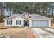 Charming single-Gathering home featuring a two-car garage and inviting front yard at 11765 Fairway Overlook, Fayetteville, GA 30215