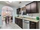 Modern kitchen featuring dark cabinetry, granite countertops, and stainless steel appliances at 11765 Fairway Overlook, Fayetteville, GA 30215