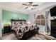 A modern main bedroom featuring a ceiling fan, a neutral wall color, and a large window at 11765 Fairway Overlook, Fayetteville, GA 30215