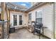 Cozy patio area with a grill, string lights, and access to the home through double doors, perfect for outdoor cooking at 11765 Fairway Overlook, Fayetteville, GA 30215