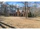 Brick home with an expansive backyard, a brick chimney, and mature trees at 3000 Cathedral Pl, Decatur, GA 30034