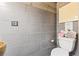 Bathroom featuring a toilet, ceramic tiling, and a decorative display on top of the toilet at 3000 Cathedral Pl, Decatur, GA 30034