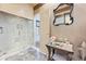 Bathroom with a glass enclosed marble shower and zebra print rug visible through doorway at 3000 Cathedral Pl, Decatur, GA 30034