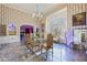 Formal dining room with a large glass table, ornate chairs, and a decorative chandelier beneath a high ceiling at 3000 Cathedral Pl, Decatur, GA 30034