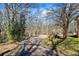 Private driveway winding through wooded landscape, leading to the residence at 3000 Cathedral Pl, Decatur, GA 30034