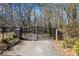 Elegant gated entrance featuring stone pillars and wrought iron gates at 3000 Cathedral Pl, Decatur, GA 30034