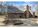 Charming brick home with a brick chimney, mature trees and a stone arch entryway at 3000 Cathedral Pl, Decatur, GA 30034