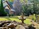 Tranquil front yard featuring a charming water fountain and lush greenery at 3000 Cathedral Place, Decatur, GA 30034