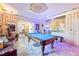 Entertainment room with a pool table, decorative walls and ceiling, and an adjacent seating area at 3000 Cathedral Pl, Decatur, GA 30034