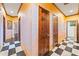 Hallway with black and white checkered tile floors, wooden doors, and unique wall finish at 3000 Cathedral Pl, Decatur, GA 30034