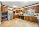 Well-lit kitchen with wooden cabinets, stainless steel appliances, tile flooring, and a window over the sink at 3000 Cathedral Pl, Decatur, GA 30034