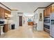 Open kitchen view boasting wood cabinets, stainless steel appliances, and tile flooring at 3000 Cathedral Pl, Decatur, GA 30034