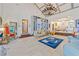 Living room featuring elegant chandeliers, shelving, tiled floors, and ornate furniture at 3000 Cathedral Pl, Decatur, GA 30034