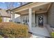 Inviting front porch featuring classic columns, a wreath-adorned door, and well-maintained landscaping at 5093 Glencliff Dr, Sugar Hill, GA 30518