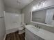 Bathroom featuring a vanity with wood-look floors, a shower, tub, and a large mirror at 104 Westland Sw Ct, Marietta, GA 30064