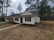 Charming home featuring black door and shutters and yellow siding at 104 Westland Sw Ct, Marietta, GA 30064