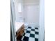 A bathroom features checkered tile floors, wood cabinets, a toilet, and a shower/tub at 11006 Clearwater Dr, Hampton, GA 30228