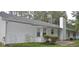 The rear exterior of this home shows white siding, a chimney, and a small patio at 11006 Clearwater Dr, Hampton, GA 30228