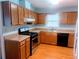 Efficient kitchen featuring wood cabinetry and stainless steel appliances at 11006 Clearwater Dr, Hampton, GA 30228