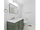 Bathroom features a marble countertop, green cabinets, modern faucet and a decorative mirror at 1889 Cannon St, Decatur, GA 30032