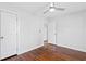 Bedroom with hardwood floors, ceiling fan, white paint, and two paneled doors at 1889 Cannon St, Decatur, GA 30032