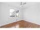 Bedroom featuring new hardwood floors, updated trim, white paint, and a ceiling fan at 1889 Cannon St, Decatur, GA 30032