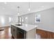 Bright kitchen with a breakfast bar island, new stainless appliances and hardwood floors at 1889 Cannon St, Decatur, GA 30032